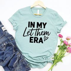 In My Let Them Era Tee